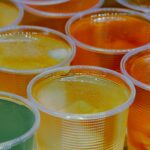 clear glass jars with yellow, orange, and green jello