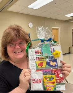 Annette Teepe is holding a Color for Joy coloring book bundle