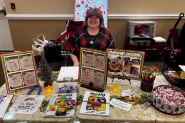 Annette Teepe at author table at Legacy Cares Christmas Market